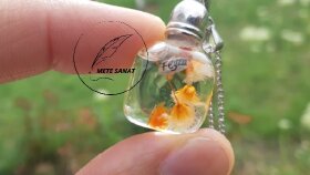 pirinç tanesi üzerine yazılmış ,isimli kolye